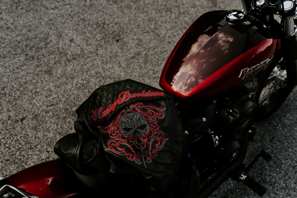 Close-up lifestyle photography of a Harley Davidson leather jacket on the back of a motorcycle in East TN.