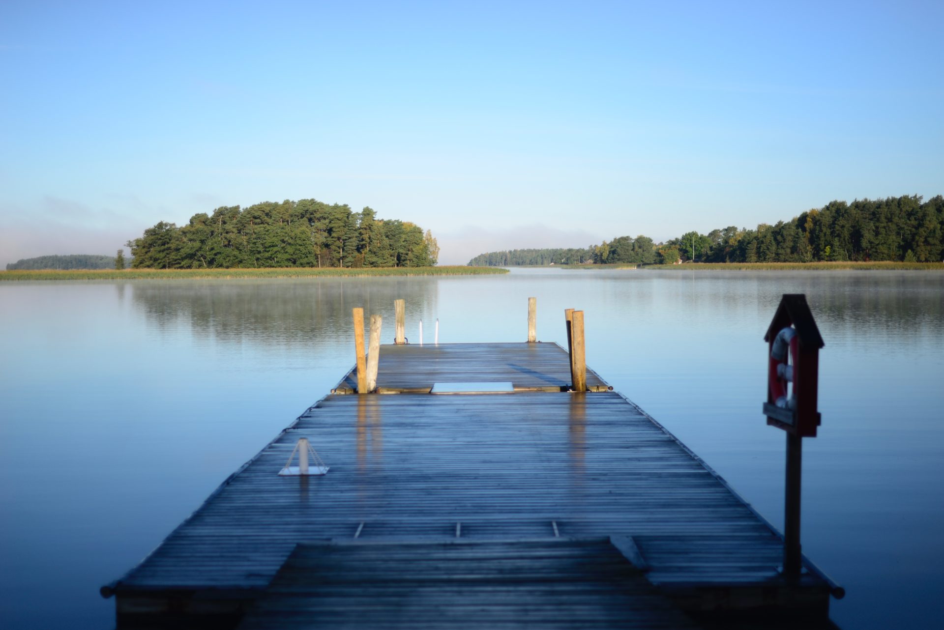 Photo of dock extending forward into a lake