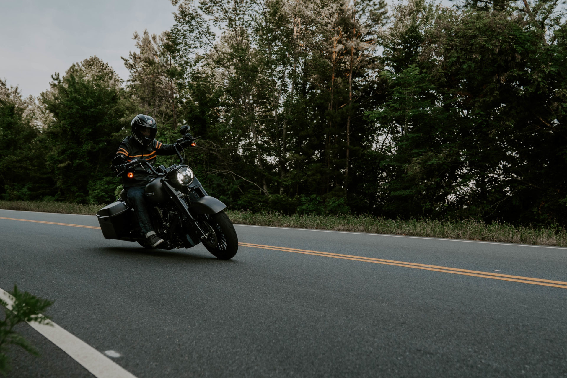 Lifestyle photography of a man riding a black motorcycle on the Foothills Parkway in East TN.
