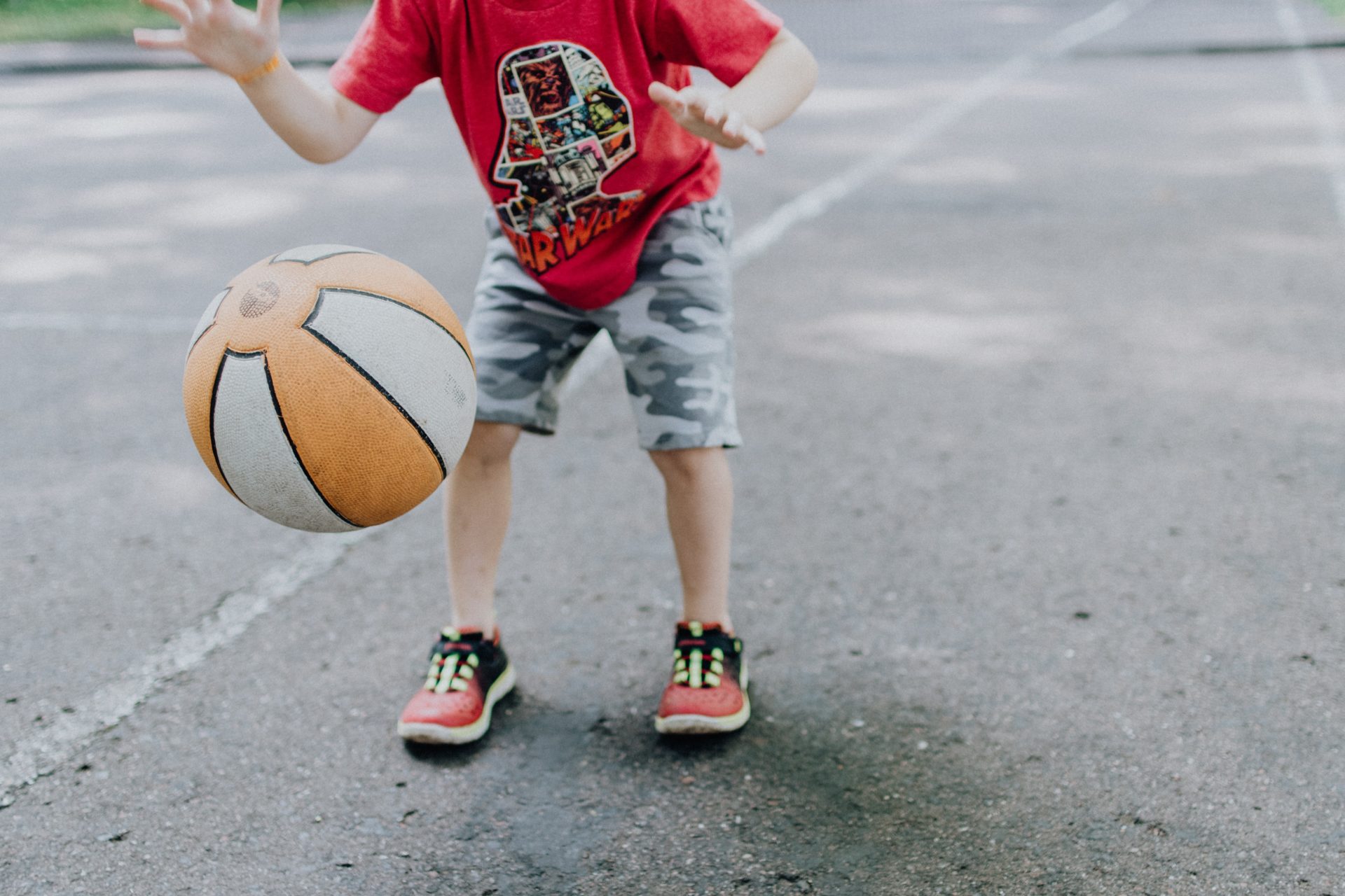 young child bouncing a basketball