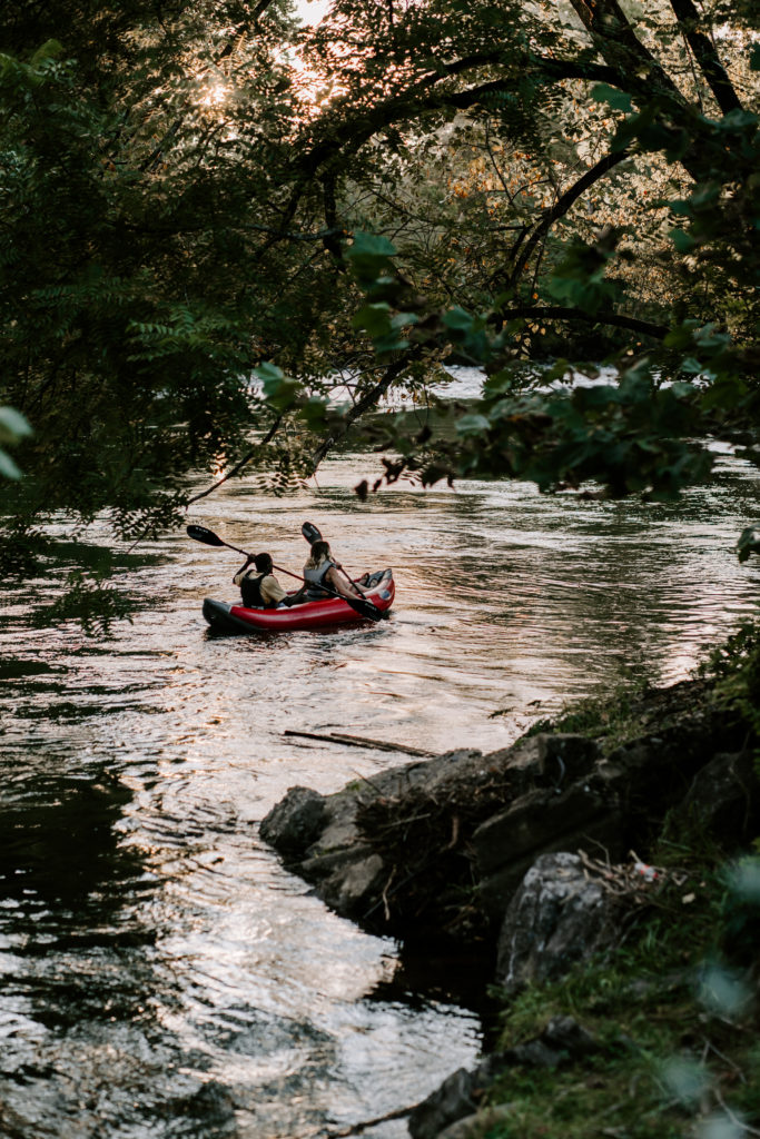 Lifestyle photography of a couple kayaking in the Little River in Townsend, TN.