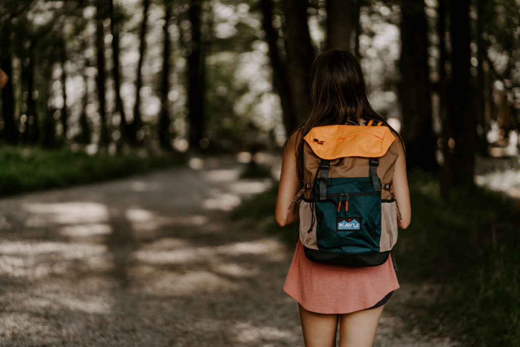Lifestyle photography of a girl hiking in Cades Cove with a Kavu Backpack in East TN.