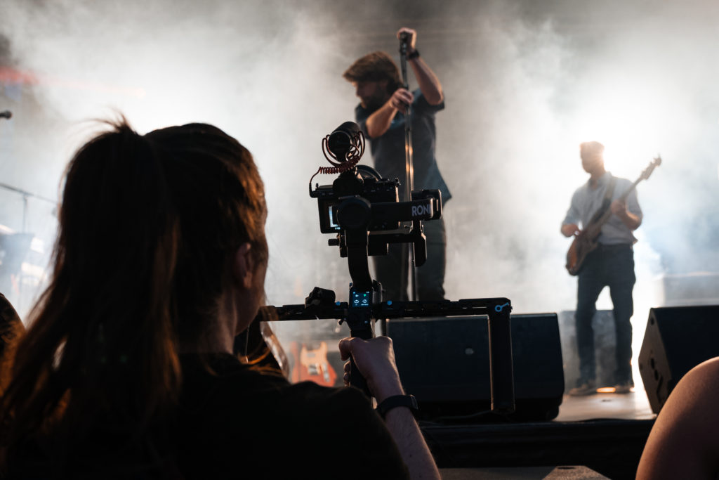 Carrie Hulsey using a gimbal to shoot a concert