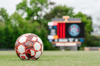 A soccer ball in front of the scoreboard at Regal Stadium at the University of Tennessee