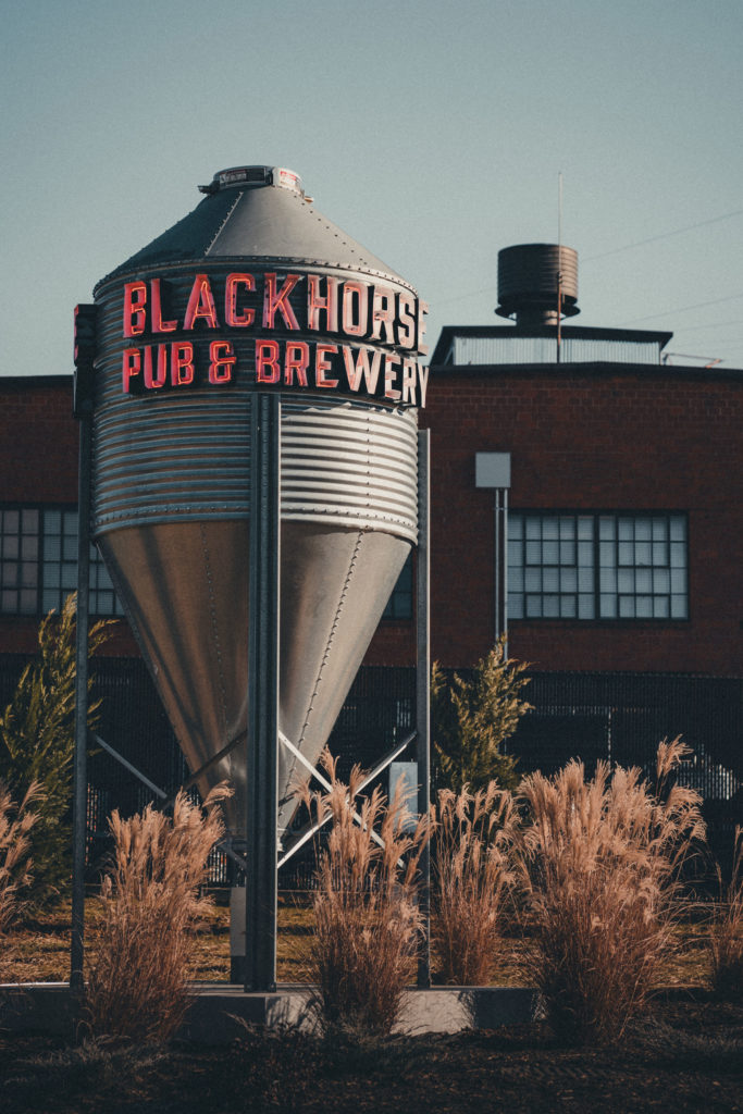 Commercial Photography of a silo with neon lettering at Blackhorse Pub and Brewery in Knoxville, TN.