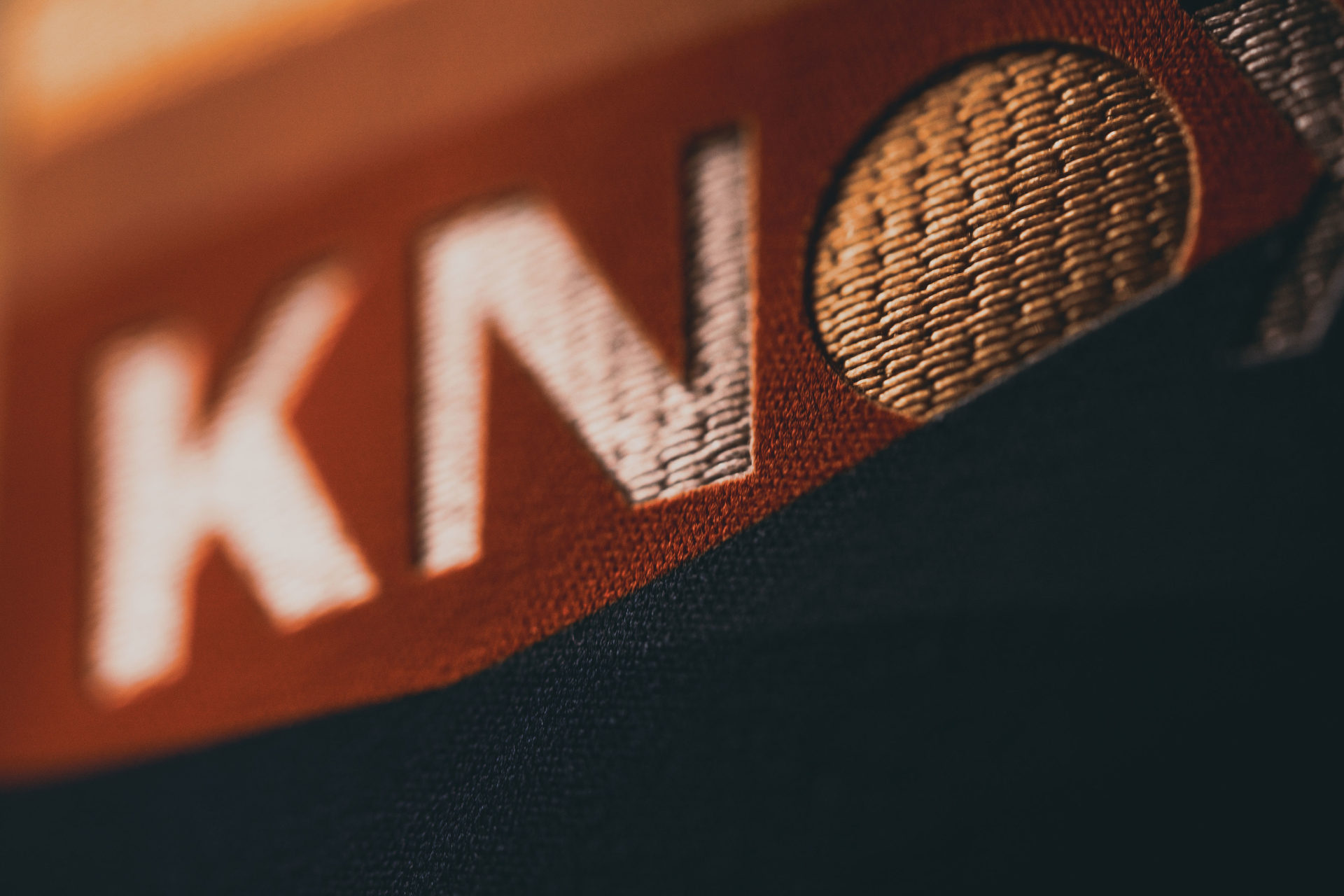 Close-up product photography of OneKnox logo with visible texture.