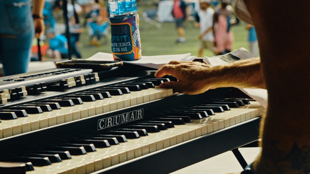 Close-up event photography of a man's hand as he plays a keyboard at a festival in Maryville, TN.