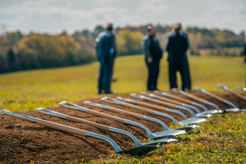 Event photography of metal shovels lined up at a groundbreaking event in East Tennessee.
