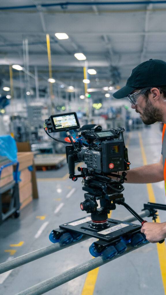 Phillip Bootsma with a camera filming BSH employees