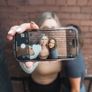 Two girls taking a selfie on an iPhone