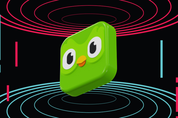 3D illustration of Duolingo’s green owl mascot, Duo, rendered as a shiny cube-shaped icon floating against a black background. Surrounding it are red and blue concentric circles and vertical bars, creating a futuristic, digital aesthetic.